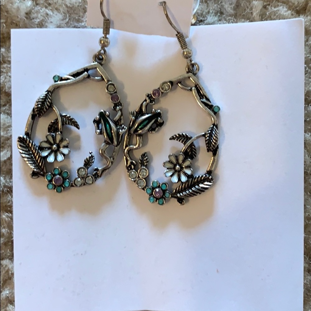 Silver earrings with flowers and leaves in it